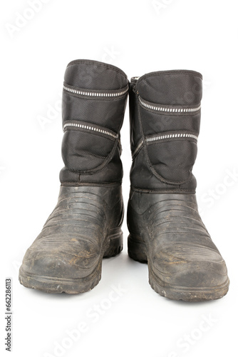 Dirty insulated old boots on a white background. Hiking boots.