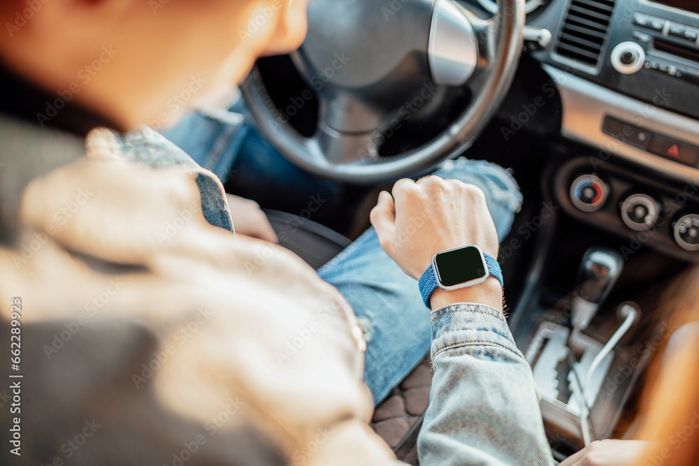 smart watch on the hand of car driver, close up. transport, business trip, technology, time and people concept