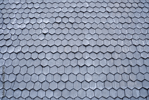 wooden tiles on the roof of a historic building. Wooden shingle roof. Wooden surface texture.