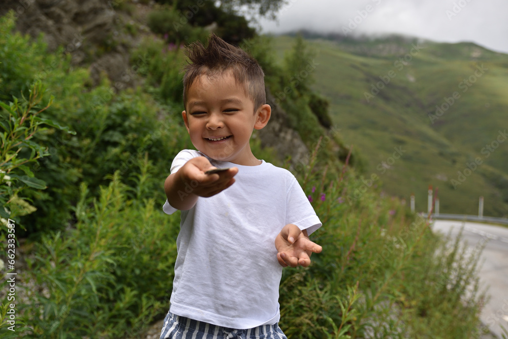 Happy kid smiling, traveling at Pyrinees Happy kid smiling, traveling at Pyrinees
