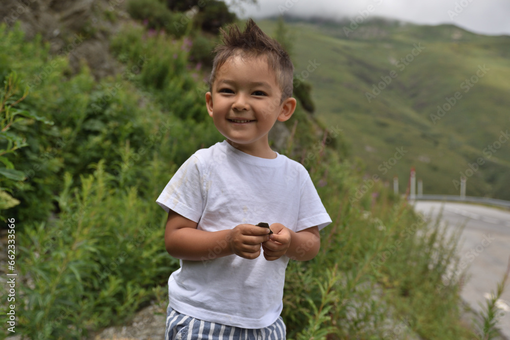 Happy kid smiling, traveling at Pyrinees Happy kid smiling, traveling at Pyrinees