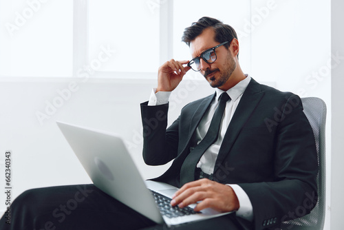 Happy man winner victory success businessman workplace business technology office chair job laptop yes