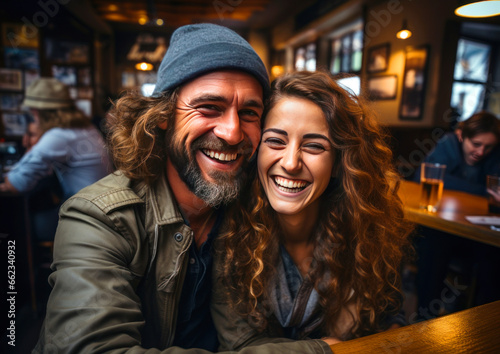 happy laughing couple relaxing in bar, going out on weekend