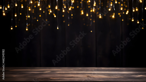 Black Christmas background wooden table with gold lights on abstract defocused dark background