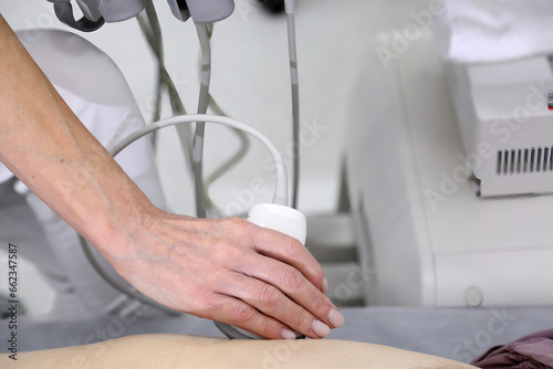 Ultrasonic examination of internal organs. A man on an abdominal ultrasound scan. Apparatus for ultrasonic examination. Modern ultrasound machine. 