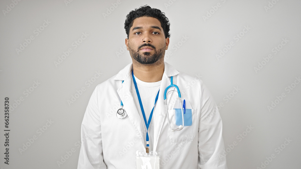 African american man doctor standing with serious expression over isolated white background African american man doctor standing with serious expression over isolated white background