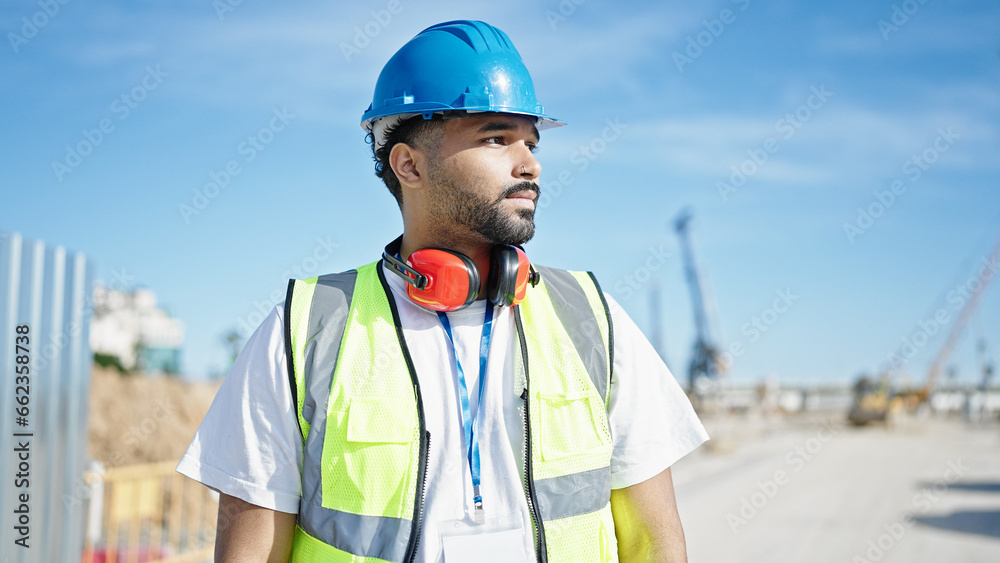 African american man builder standing with relaxed expression at street African american man builder standing with relaxed expression at street