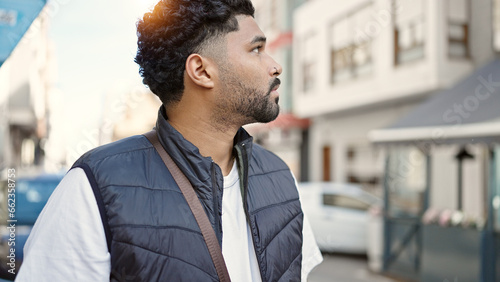 African american man looking to the side with serious expression at street