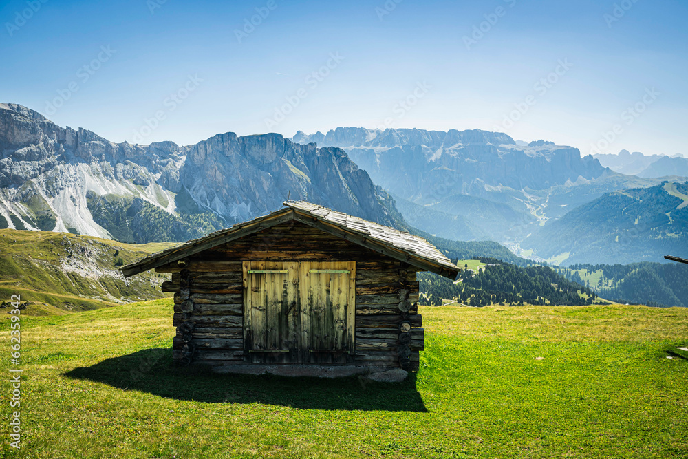 A Stadel, or grain storage barn, high in the alpine region of the Italian Dolomites on a clear, sunny day.