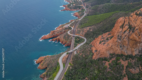 Aerial view of the Massif de L'Esterel and a beautiful winding road over the cliffs falling into the Mediterranean Sea. French Riviera. Cote d'Azur photo