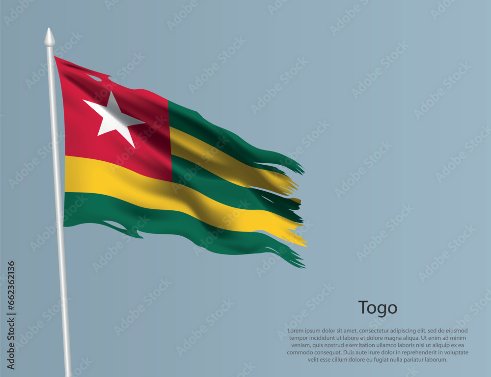 Ragged national flag of Togo. Wavy torn fabric on blue background
