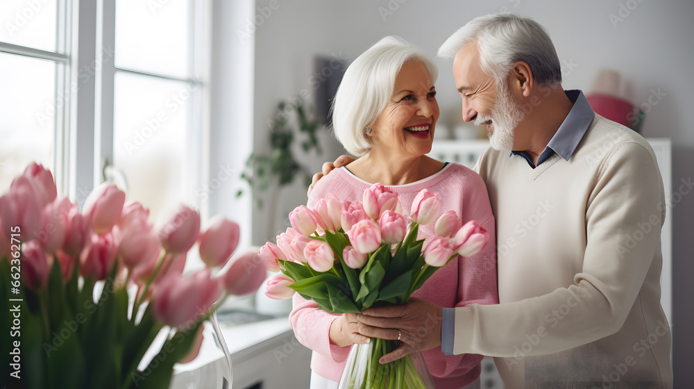 Un homme qui offre un bouquet de fleurs pour l'anniversaire de sa femme.  - obrazy, fototapety, plakaty 