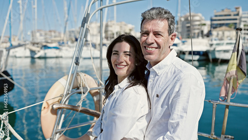 Senior man and woman couple smiling confident hugging each other at boat