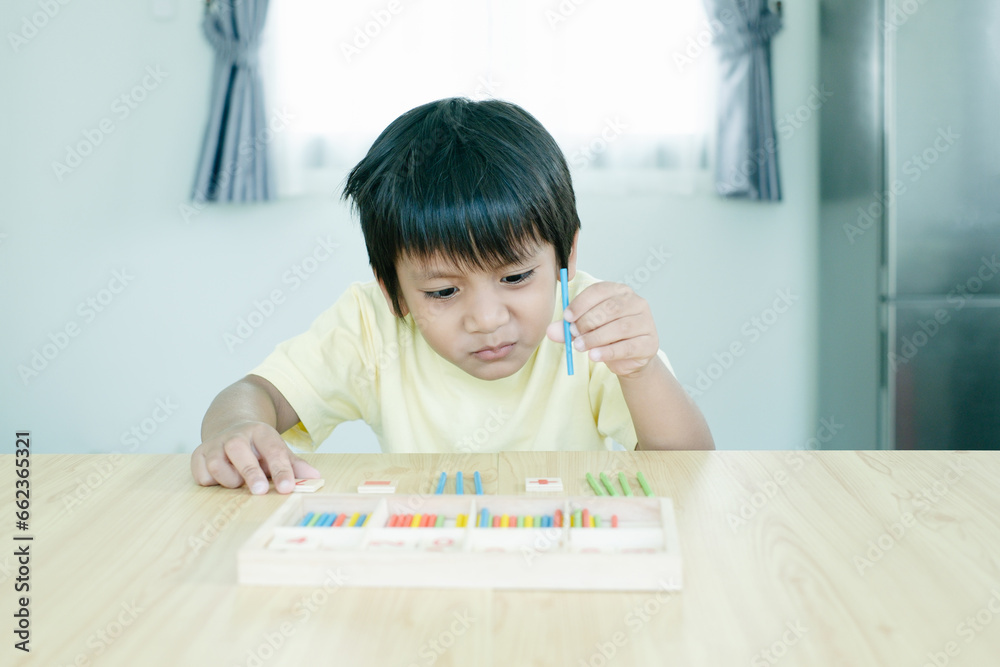 Asian kindergarten kid calculate and solve math problem. Little smart boy learning mathematics. Asian kindergarten kid calculate and solve math problem. Little smart boy learning mathematics.