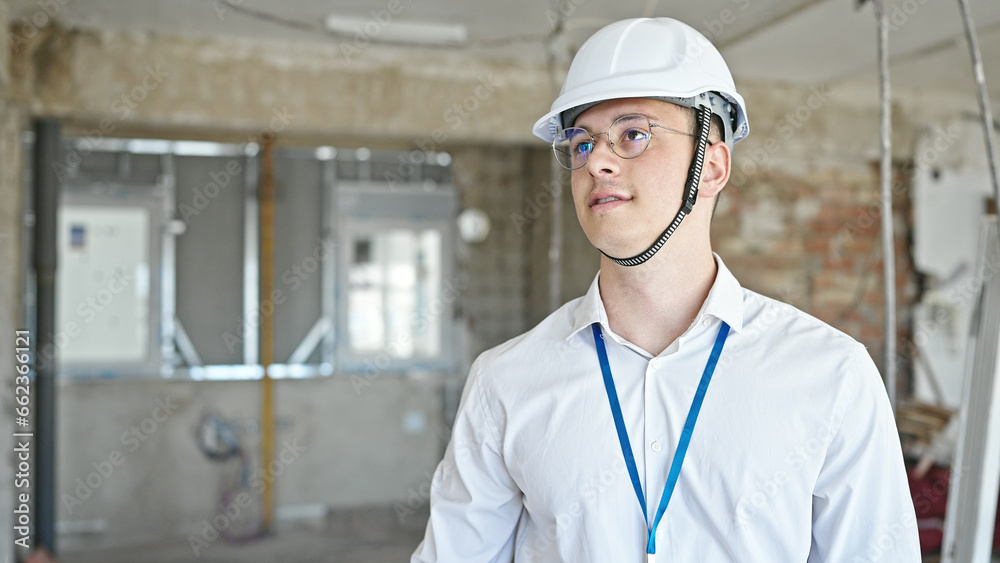 Young hispanic man architect standing with relaxed expression at construction site Young hispanic man architect standing with relaxed expression at construction site