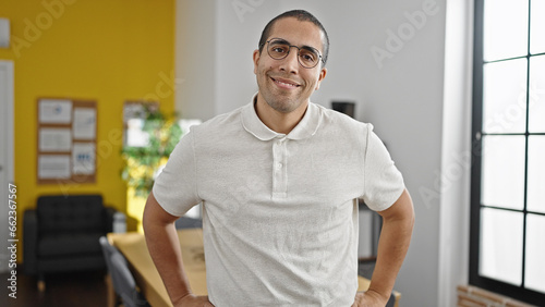 Young hispanic man business worker smiling confident at office