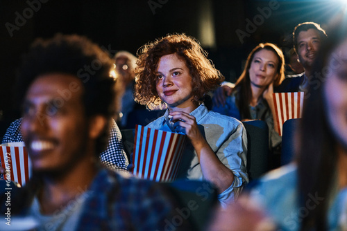Young woman watching a movie in a cinema photo