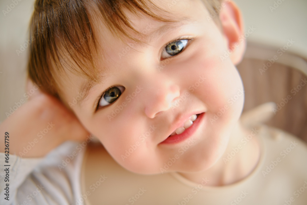 Face toddler baby waiting for food sitting in a bib. Kid boy aged two years (two-year-old) Face toddler baby waiting for food sitting in a bib. Kid boy aged two years (two-year-old)