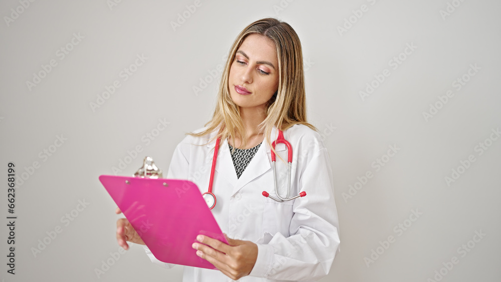Young blonde woman doctor reading document on clipboard over isolated white background Young blonde woman doctor reading document on clipboard over isolated white background