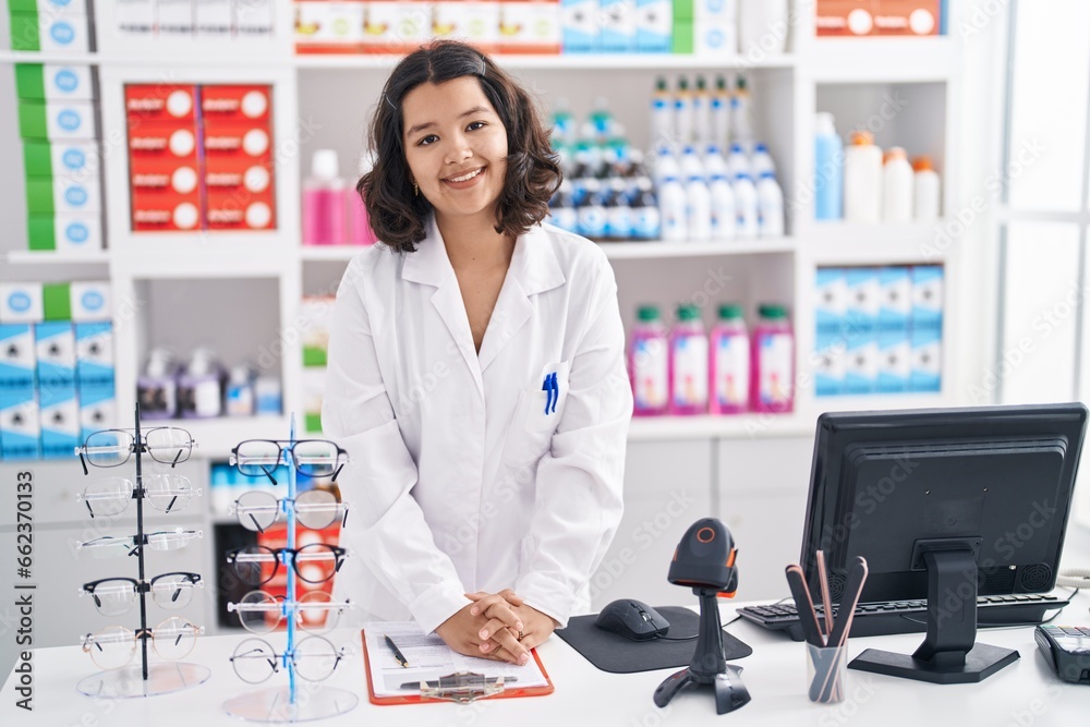 Young woman pharmacist smiling confident standing at pharmacy Young woman pharmacist smiling confident standing at pharmacy