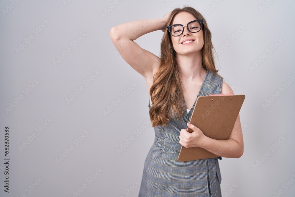 Caucasian woman wearing glasses and business clothes smiling confident touching hair with hand up gesture, posing attractive and fashionable Caucasian woman wearing glasses and business clothes smiling confident touching hair with hand up gesture, posing attractive and fashionable