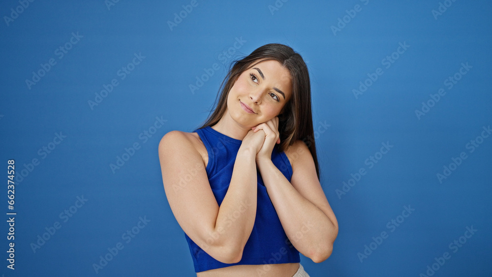 Young beautiful hispanic woman smiling confident thinking over isolated blue background