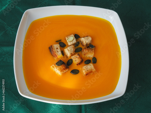 Pumpkin soup with croutons and pumpkin seeds photo