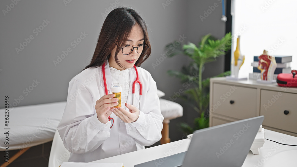 Young chinese woman doctor having video call prescribe pills treatment at clinic Young chinese woman doctor having video call prescribe pills treatment at clinic