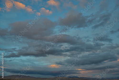 Russia. The South of Western Siberia. Gloomy sunset clouds in the evening summer sky over the fields of Altai.