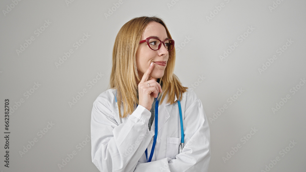 Young blonde woman doctor standing with doubt expression thinking over isolated white background Young blonde woman doctor standing with doubt expression thinking over isolated white background