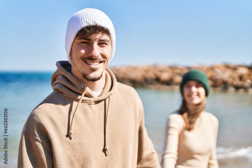 Mand and woman couple standing together with hands together at seaside