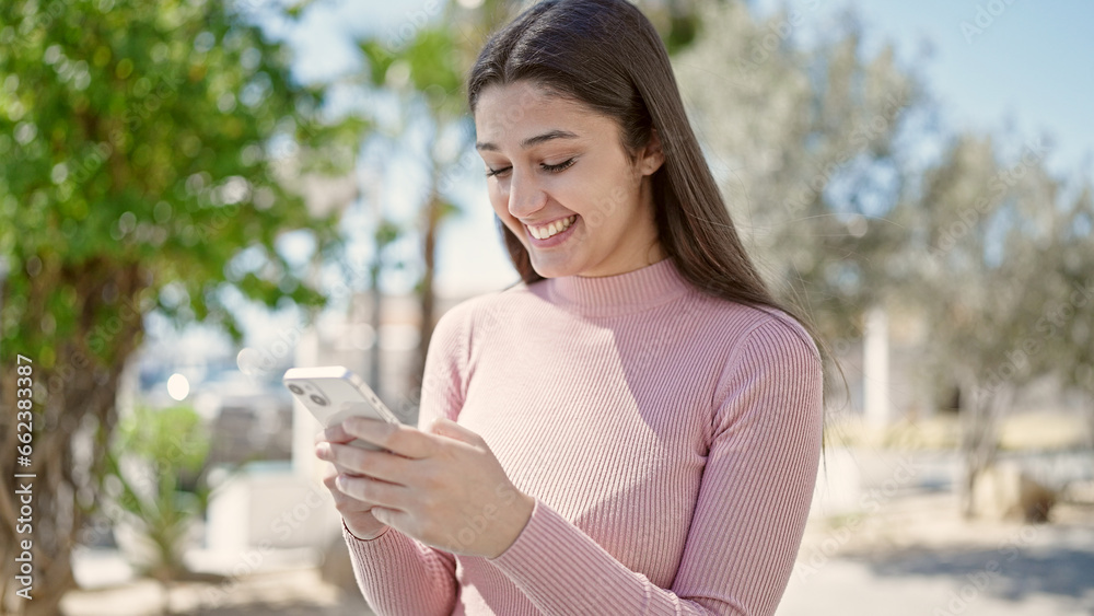Young beautiful hispanic woman smiling confident using smartphone at park Young beautiful hispanic woman smiling confident using smartphone at park