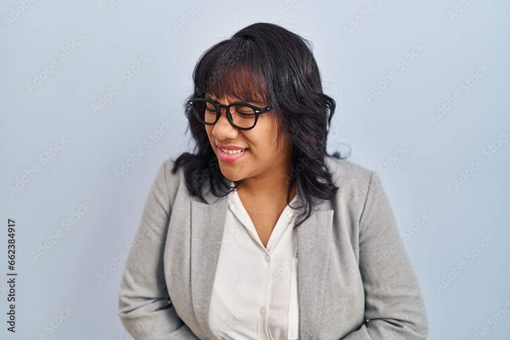 Hispanic woman standing over isolated background with hand on stomach because nausea, painful disease feeling unwell. ache concept. Hispanic woman standing over isolated background with hand on stomach because nausea, painful disease feeling unwell. ache concept.