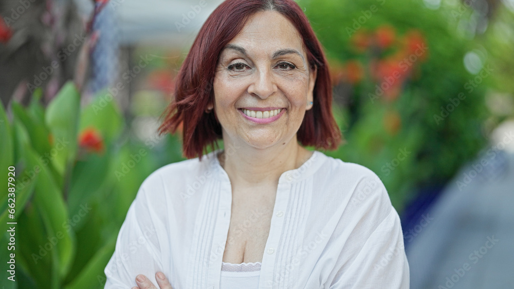 Middle age woman smiling confident standing at park Middle age woman smiling confident standing at park