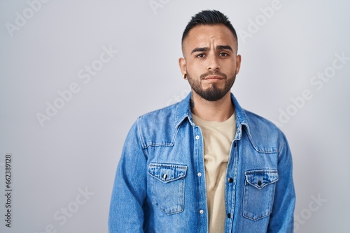Young hispanic man standing over isolated background depressed and worry for distress, crying angry and afraid. sad expression. © Krakenimages.com