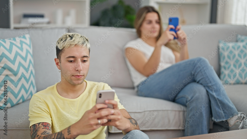 Beautiful couple using smartphones at home Beautiful couple using smartphones at home