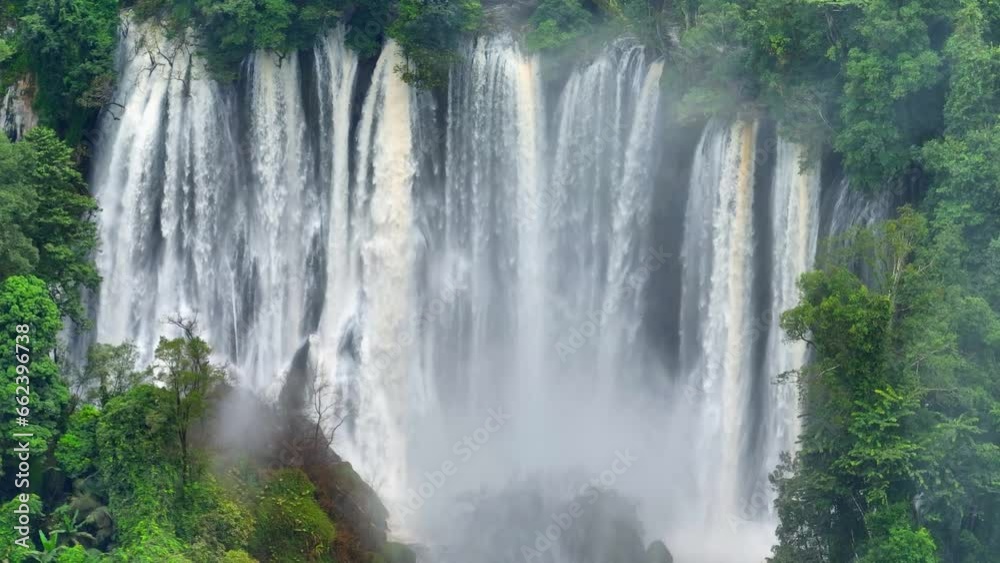 A mesmerizing secret of the jungle, an expansive waterfall emerges from the depths of a vibrant, impenetrable rainforest, captured from above by a drone. Wild Woods: Nature Sanctuary. Thailand.
A mesmerizing secret of the jungle, an expansive waterfall emerges from the depths of a vibrant, impenetrable rainforest, captured from above by a drone. Wild Woods: Nature Sanctuary. Thailand.
