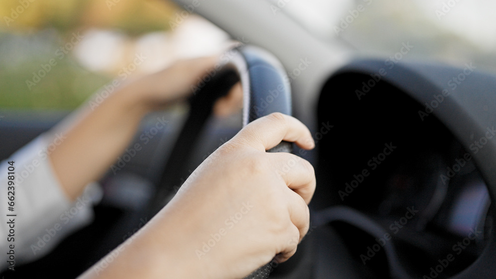 Young beautiful hispanic woman driving a car on the road Young beautiful hispanic woman driving a car on the road
