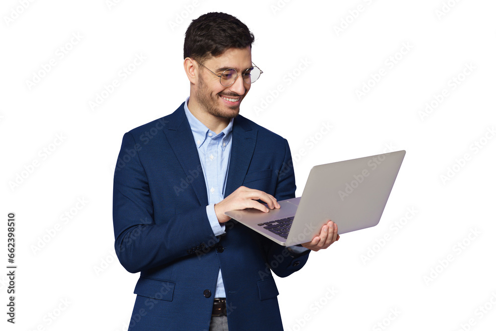 Young male teacher dressed in blue suit, wearing glasses, holding open laptop in hands, looking at screen