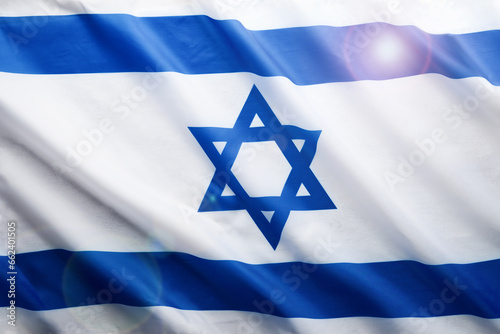 Israel flag. Independence Day of Israel. Israel flag beautifully waving wave with star of David over white wooden background. National pride of Israel. Patriotism and commonwealth. Top view. Mock up.
