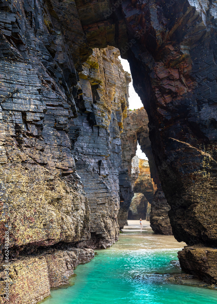 Natural rock arches Cathedrals beach, Playa de las Catedrales at Ribadeo, Galicia, Spain. Famous beach in Northern Spain Atlantic. Natural rock arch on Cathedrals beach in low tide