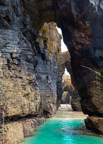 Natural rock arches Cathedrals beach, Playa de las Catedrales at Ribadeo, Galicia, Spain. Famous beach in Northern Spain Atlantic. Natural rock arch on Cathedrals beach in low tide