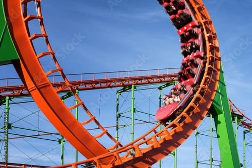 Close-up of a fun roller coaster ride. Blurred image of a train to convey movement in the frame.
