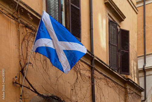 Flag of Scotland waving outside a building