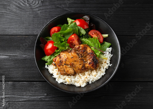 Baked balsamic chicken thighs with rice and vegetables © grinchh