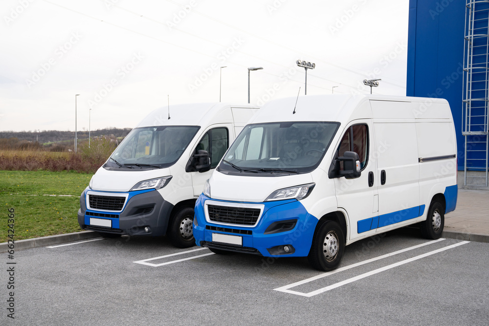 Vans are parked in row. Commercial fleet