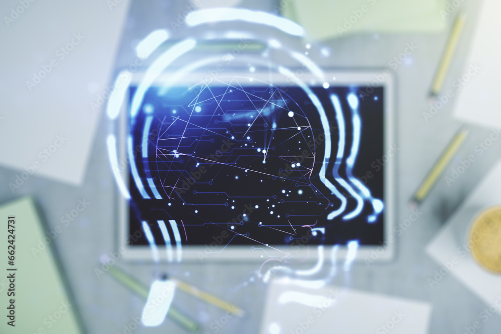 Creative artificial Intelligence concept with human head hologram and modern digital tablet on background, top view. Multiexposure Creative artificial Intelligence concept with human head hologram and modern digital tablet on background, top view. Multiexposure