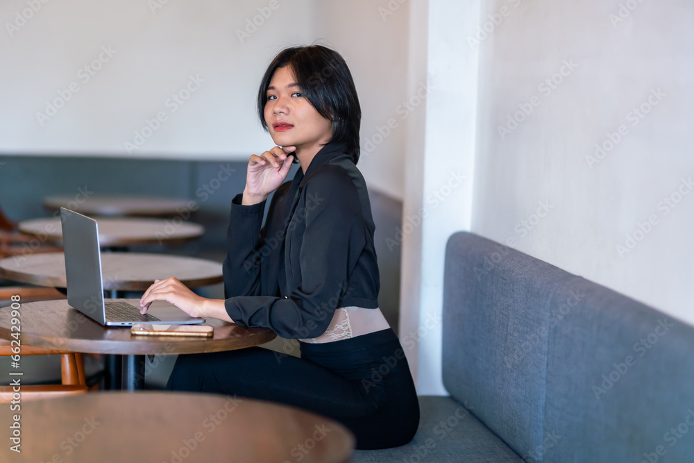 Portrait of asian freelance people businesswoman casual working with laptop computer in cafe interior in coffee shop background,business expressed confidence embolden and successful concept Portrait of asian freelance people businesswoman casual working with laptop computer in cafe interior in coffee shop background,business expressed confidence embolden and successful concept