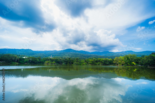 a public place leisure travel landscape lake views at Ang Kaew Chiang Mai University and Doi Suthep nature forest Mountain views spring cloudy sky background with white cloud. © Thinapob