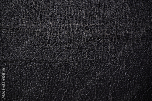close up of worn out leatherette or imitation leather with its surface already cracking and showcasing the textile-like materials used